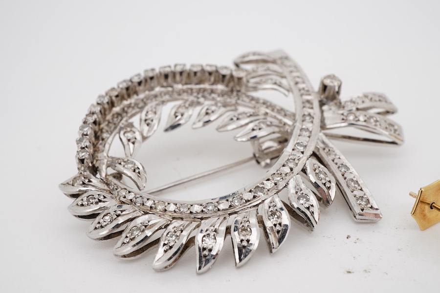A white metal and diamond cluster set scrolling brooch, 52mm, together with a pair of yellow metal and cultured pearl set ear studs.